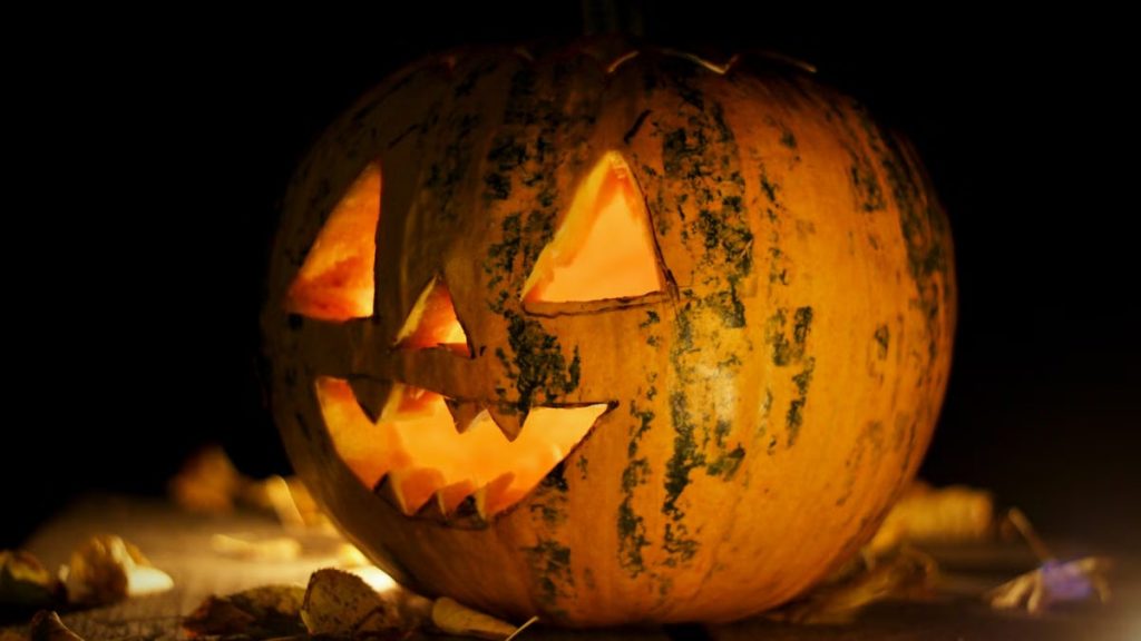 A carved and illuminated pumpkin Jack-o'-lantern creating a spooky Halloween atmosphere in Hungary.